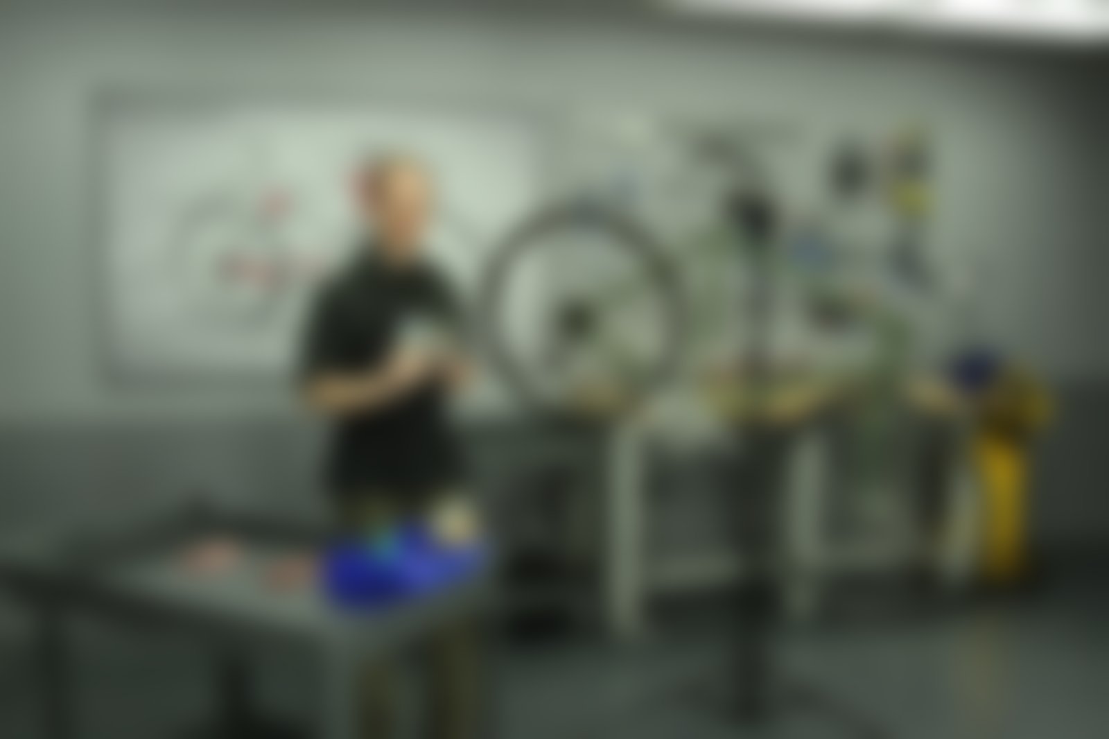 The master technician at the bench, soft focus.